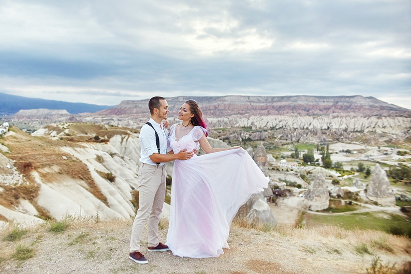 Valentine's day loving couple in nature hugs Mountains of Cappadocia in Turkey