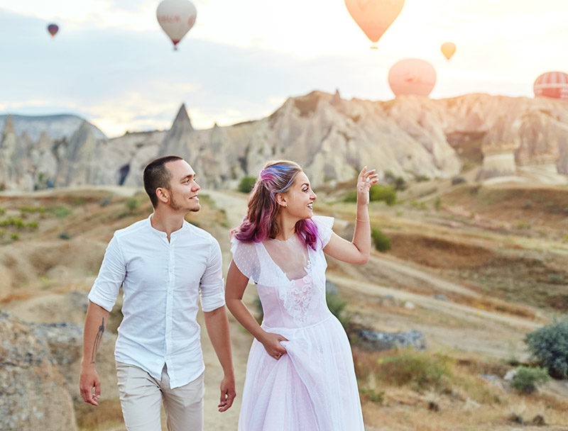 Couple in love at sunset against background of balloons in Cappadocia,