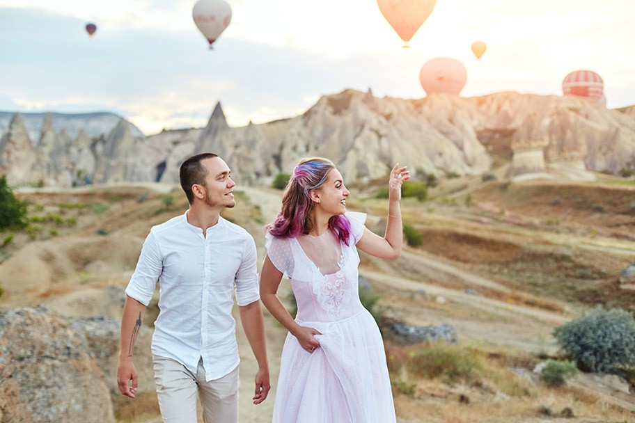 Couple in love at sunset against background of balloons in Cappadocia,