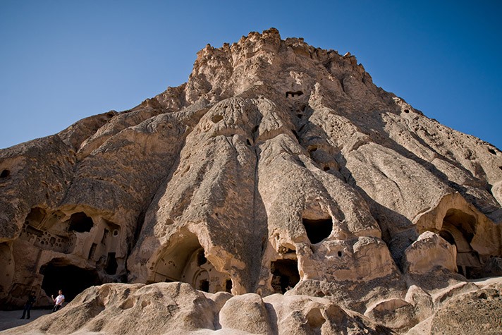 Caves excavated in the rock as dwellings in the city of Cavusin, Turkish Cappadocia.
