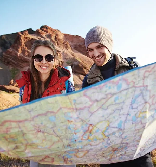 destinations of Tourists Looking at Map