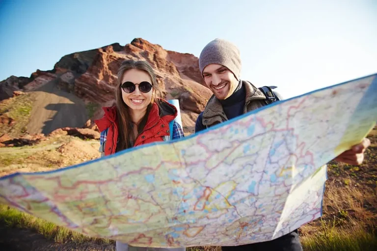 destinations of Tourists Looking at Map