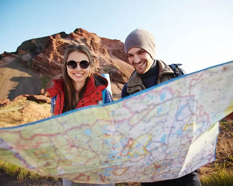 destinations of Tourists Looking at Map